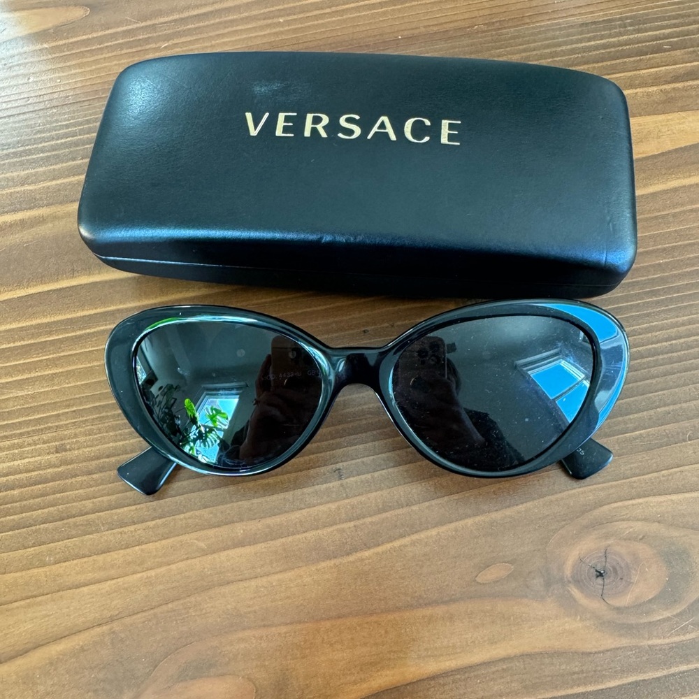 Black and gold rounded Versace sunglasses